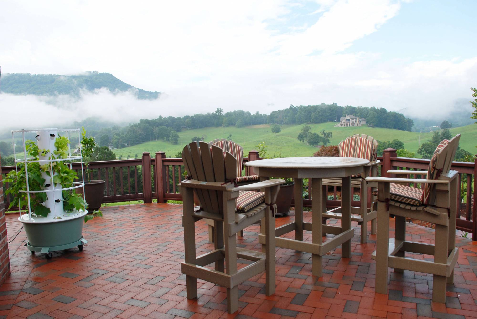 Brick patio with dining set overlooking the mountain landscape