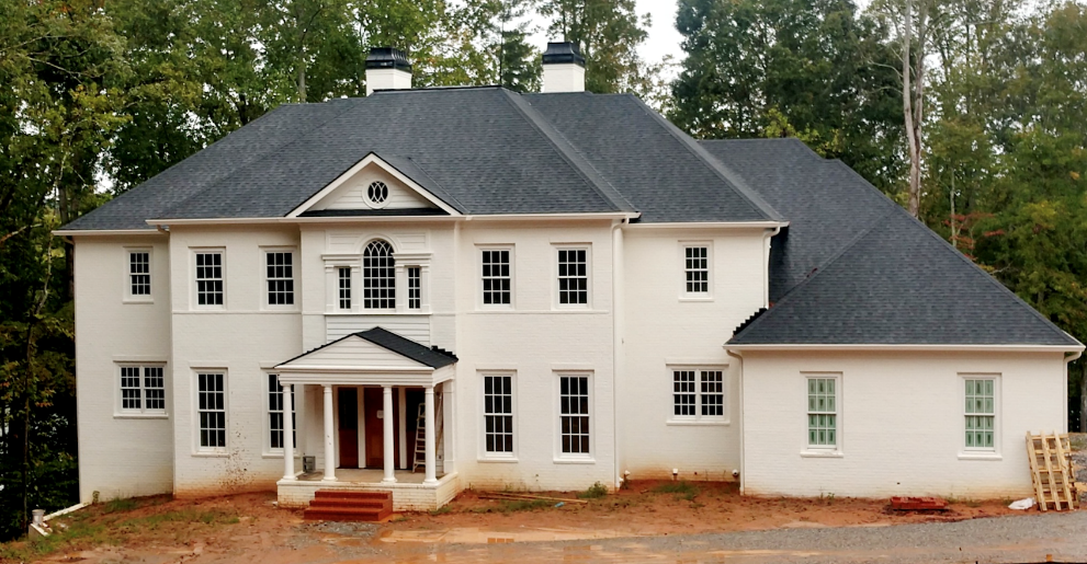 A small house in front of a building
Description automatically generated