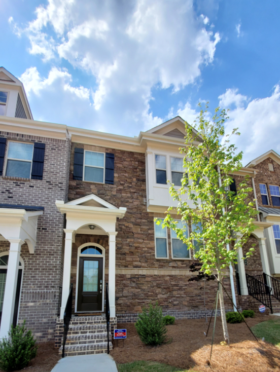 A brick building with a tree in front of it
Description automatically generated with low confidence
